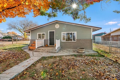 Rear view of house featuring brick siding and a patio
