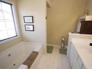 Full bath with a garden tub and vanity