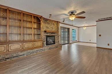Living room with built in storage & fireplace