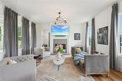 Living area featuring a notable chandelier and woo