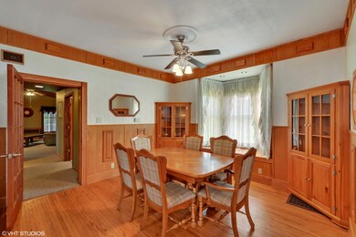 Built-in cabinetry, crown molding, and a window se