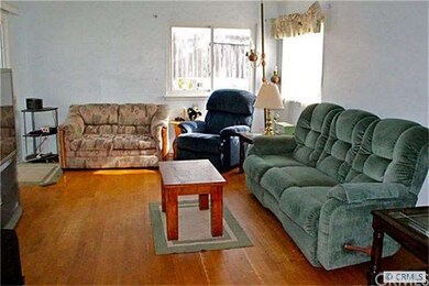 Large family room with wood floor and sliding door
