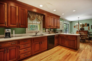 Kitchen boasts cherry cabinets, corian counter top