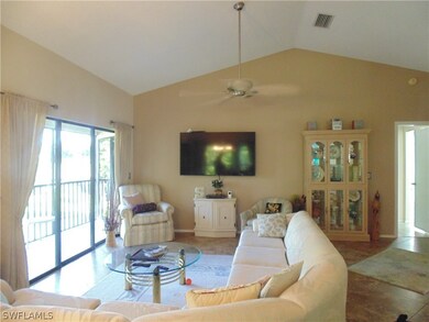 Living room with ceiling fan, lofted ceiling, and