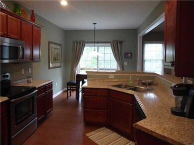 Kitchen. The kitchen features gleaming maple cabin