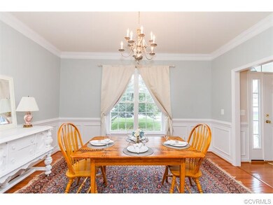 Elegant dining room with hardwood floors, molding 