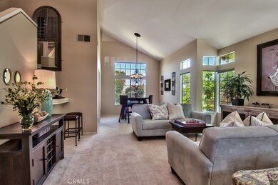 The formal and dining room area. Experience an incredibly bright floor plan featuring two-story high ceilings with a sweeping staircase and stacked windows that bring the outdoors in.