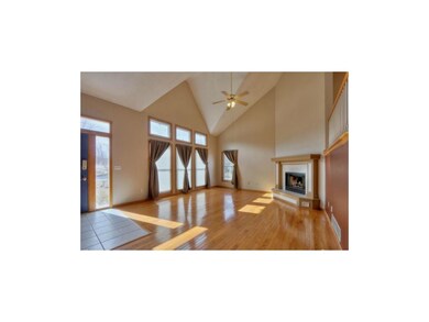 Living Room with Hardwoods, Fireplace, and Wall of