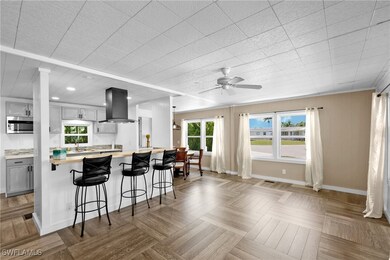 Kitchen featuring island exhaust hood, gray cabine