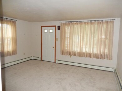 Freshly carpeted living room has great space and l