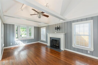 Main living with gas log fireplace and bay window