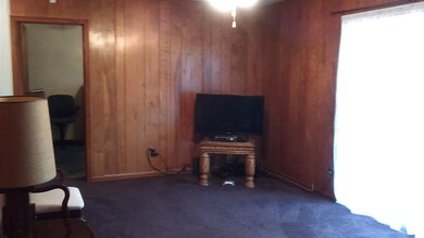 Spacious den with sliding patio door.