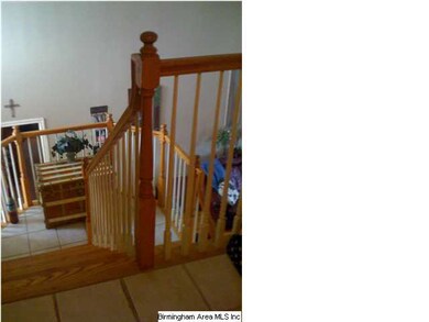 Hardwood stairs and ceramic tile landing..