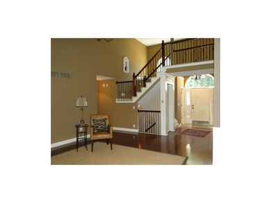 view of entry, catwalk & wrought iron spindles