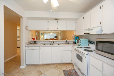 Kitchen with ceiling fan, white appliances, sink,