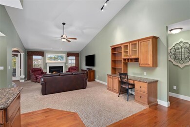 Open and bright vaulted greatroom with a gas firep