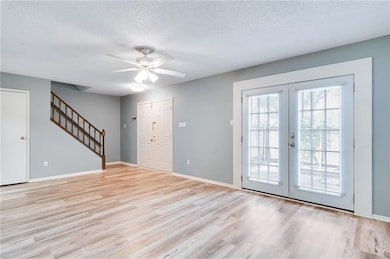 Brightest, most inviting den w/ fresh paint, laminate flooring, Double doors lead to private patio