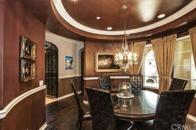 Custom silk draperies hang from beautiful arched w