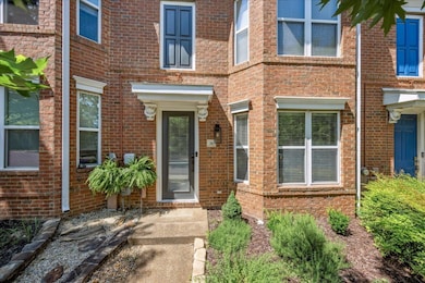View of exterior entry featuring brick siding