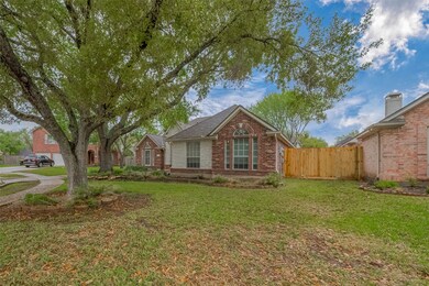 The property is surrounded by mature trees and a w