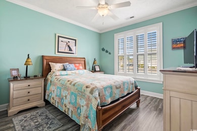 Bedroom with crown molding, a textured ceiling, ce