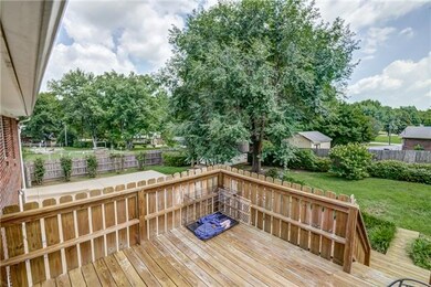 Large yard with oversized concrete parking area.