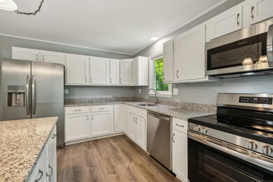 Beautifully remodeled kitchen with brand new cabinets, gorgeous granite counters, and stainless steel appliances