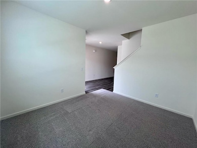 Empty room with baseboards, dark carpet, and recessed lighting