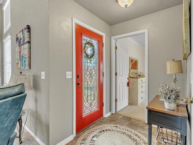 Tiled foyer entrance featuring ornamental molding 