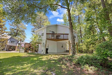 Rear view of property with a lawn, a wooden deck, a patio area, cooling unit, and stairs