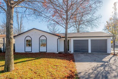 Ranch-style house with a garage and a front yard