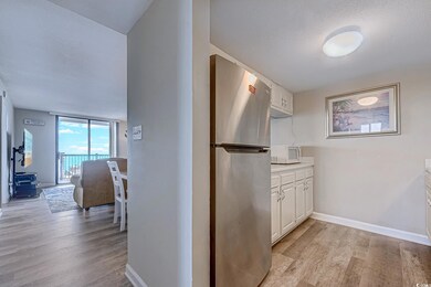 Hall featuring light wood finished floors, baseboa