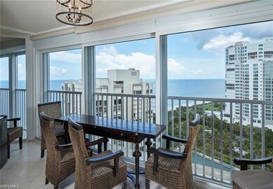 Sunroom with a water view and a chandelier