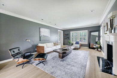 Oversized windows in the formal living expose the wonderful street and manicured landscaping in the front yard. Ample natural light streams from all angles and fills the room with light. The ambiance is complete with a handsome gas log fireplace keeping the space cozy and inviting.