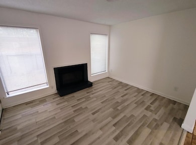Unfurnished living room with light wood finished floors and a fireplace