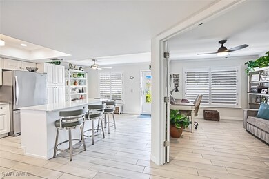 Kitchen with white cabinets, a center island, ligh