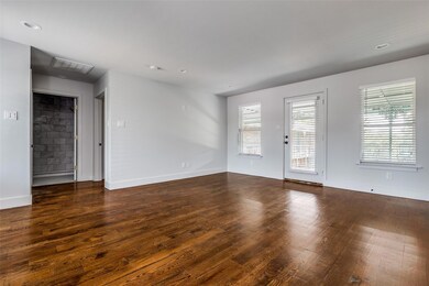 Empty room with dark hardwood / wood-style floors