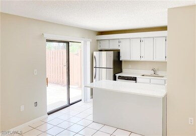 Kitchen with dishwasher, a sink, light countertops