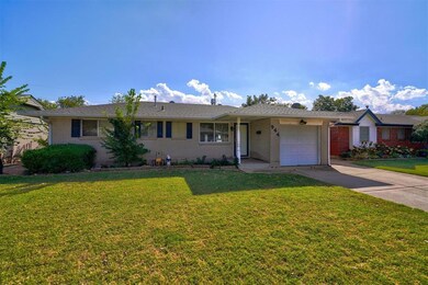Ranch-style home featuring a front lawn and a gara