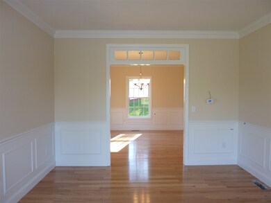 Gleaming hardwood floors. Transom window, detail m