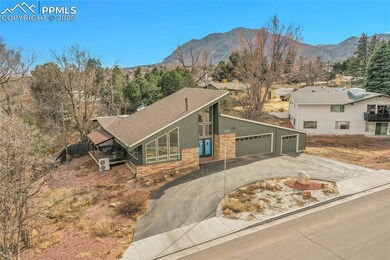 View of front of home with a garage, a mountain vi