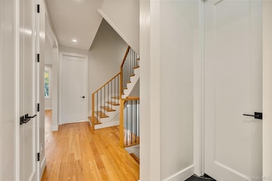 Entryway featuring light wood-style floors, recessed lighting, and stairs