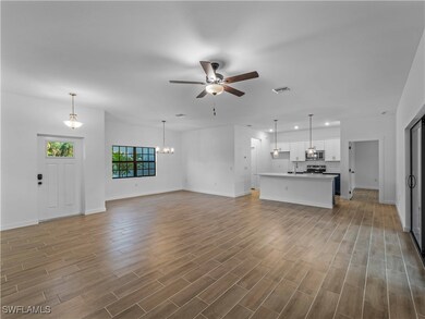 Unfurnished living room featuring ceiling fan, bas