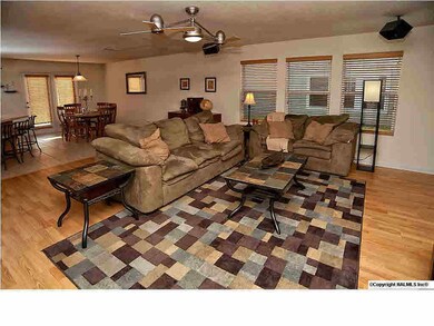 The great room has lovely laminate wood flooring & has surround sound speakers