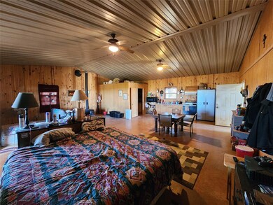 Bedroom featuring stainless steel fridge, lofted c