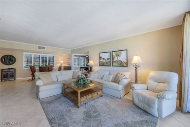 Living room with ornamental molding and light tile