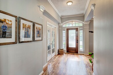 Step inside to a generous foyer filled with natural light. An enclosed office is to the left and formal dining to the right.