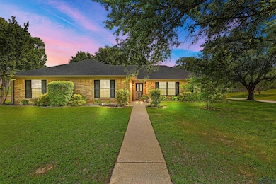 Ranch-style home featuring brick siding, roof with