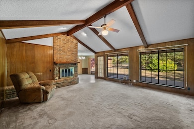 Walls of windows & brick f/p accent the living room!