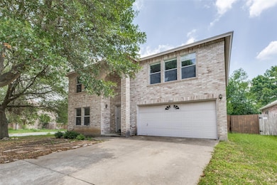 View of front of house featuring driveway, brick 